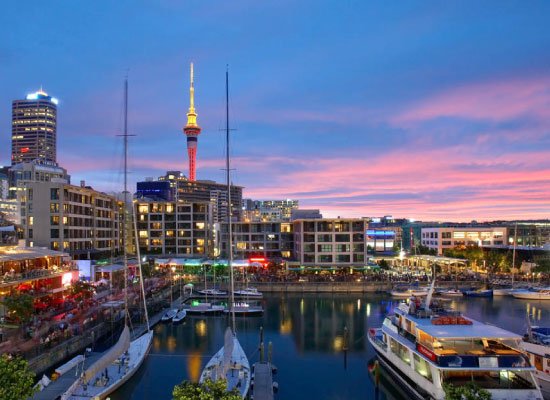 Auckland New Zealand waterfront skyline at sunset showcasing visa destination