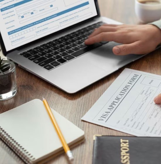 Applicant completing visa application online using laptop