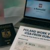 UAE passport, Poland work visa documents, and e-Konsulat portal on a laptop during visa application process